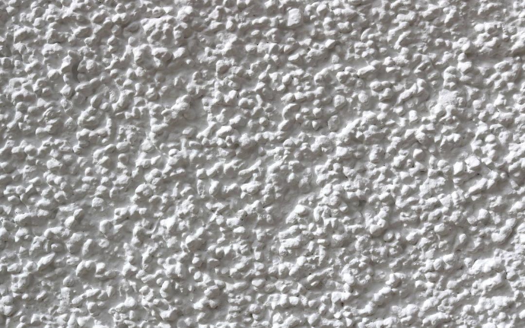 White textured stucco wall.