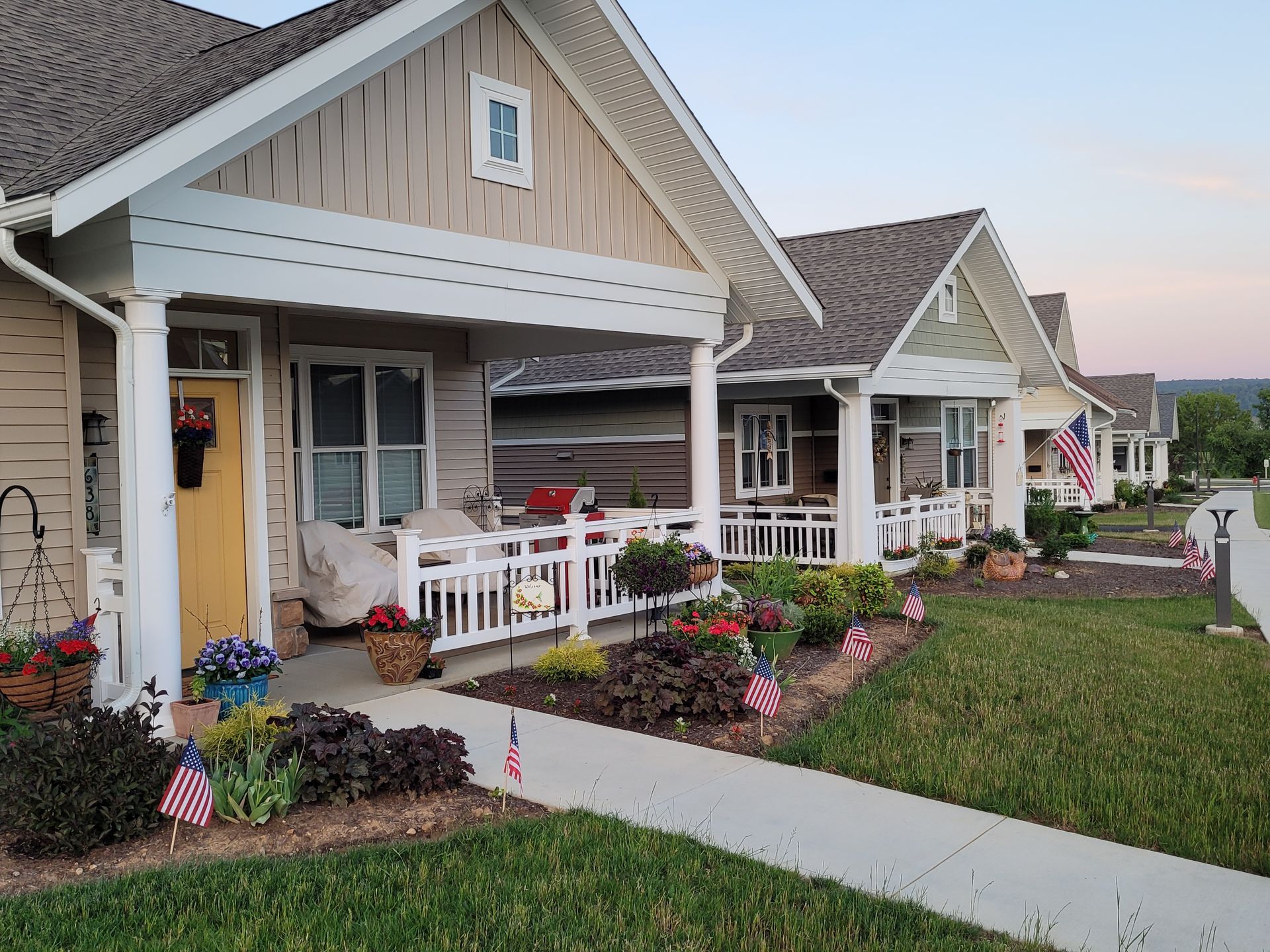 Residential cottage exterior with white vinyl railings installed by Millcreek Fence