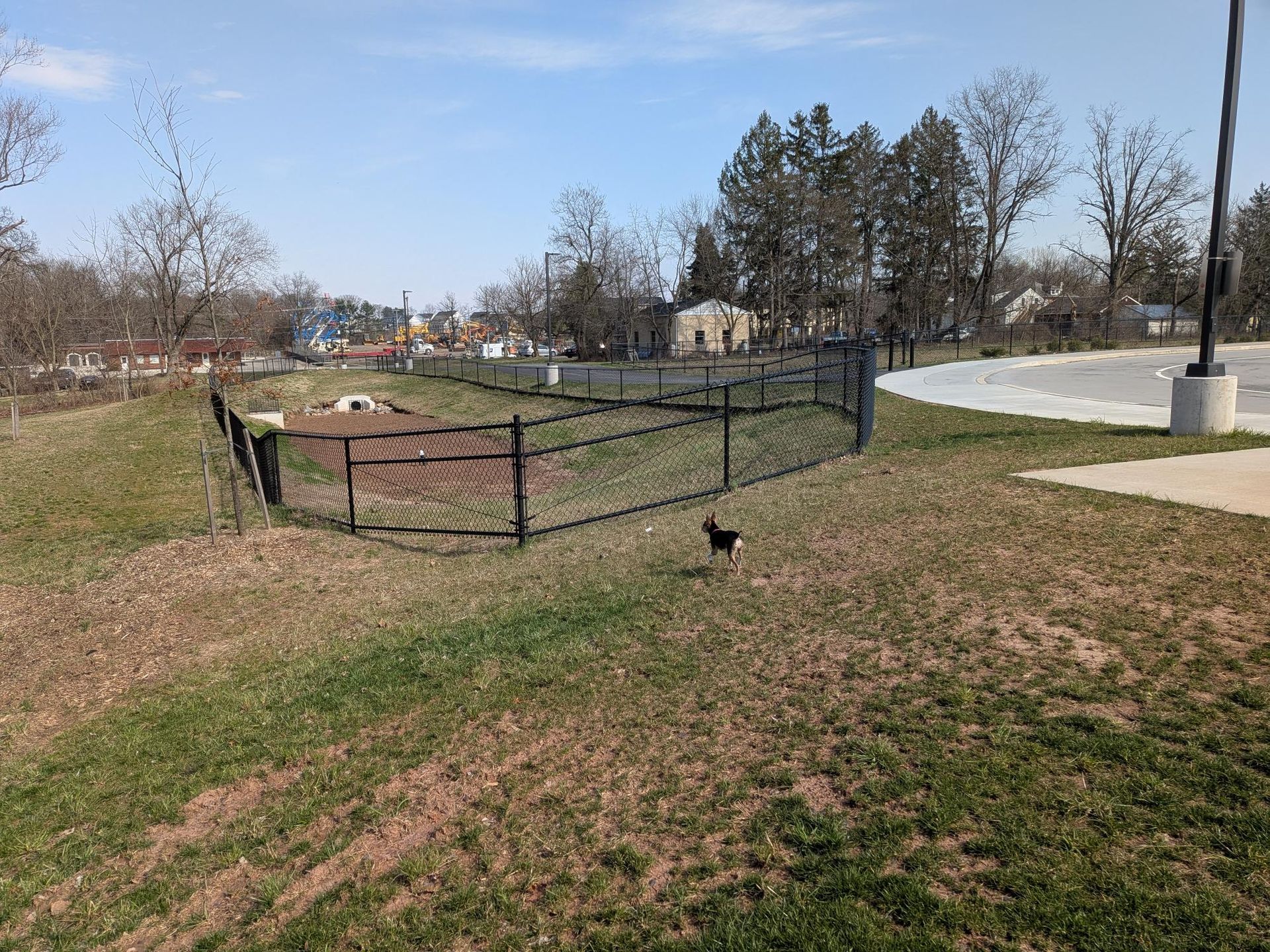 Commercial chain link fence installation for water retention area