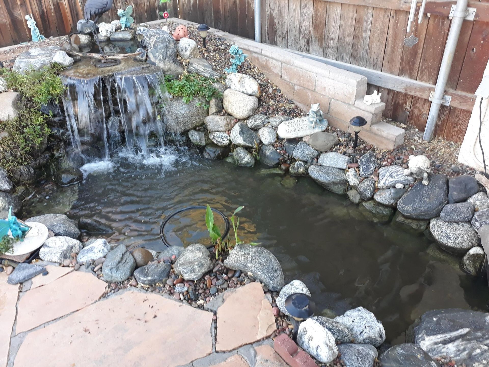 A pond with a waterfall in the middle of it