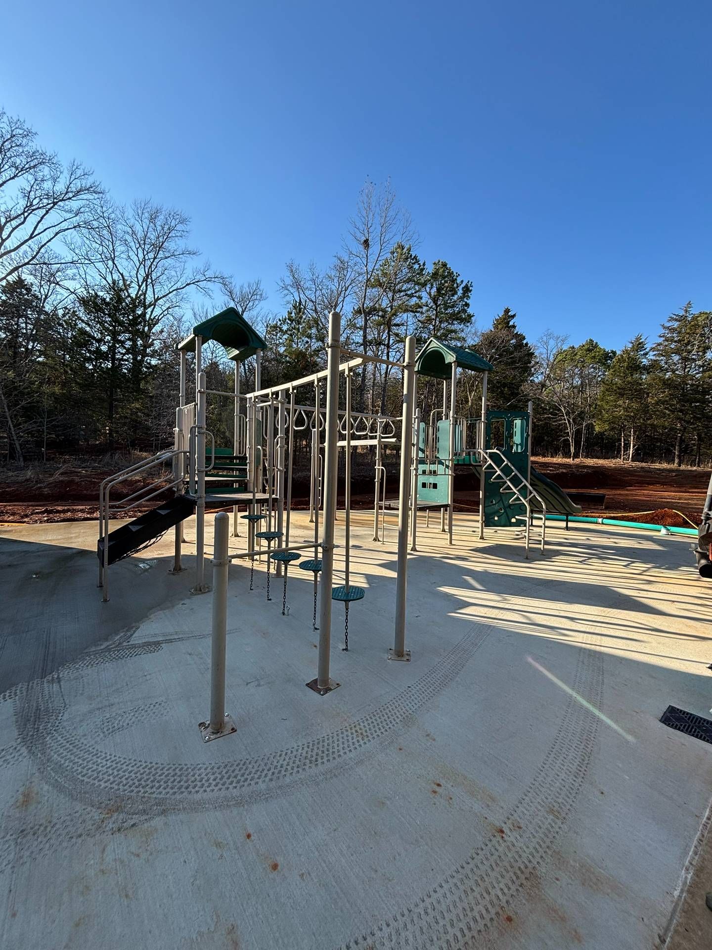 Outdoor playground with climbing poles and slides on a sunny day