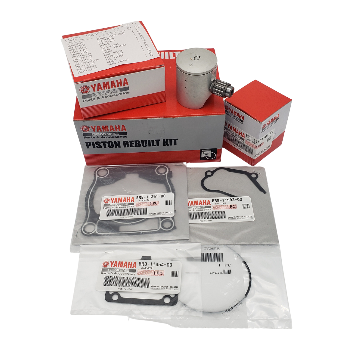 Yamaha piston rebuild kit with boxes, a piston, gaskets, and rings.