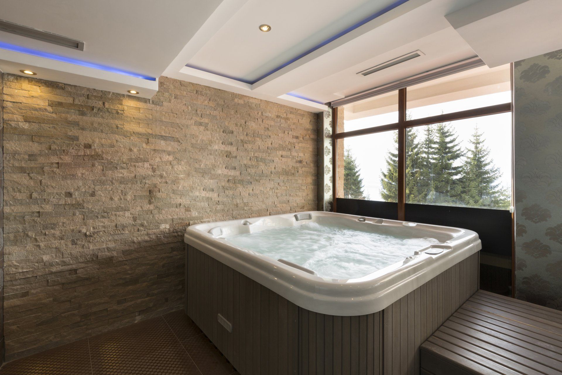 There is a large jacuzzi in the middle of the room.