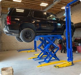 A Vehicle Lifted in Our Auto Repair Shop in Pasadena, CA - Crown City Motors
