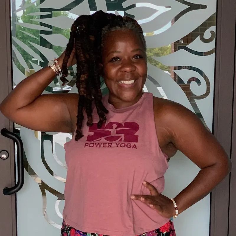 Smiling person wearing a mauve 