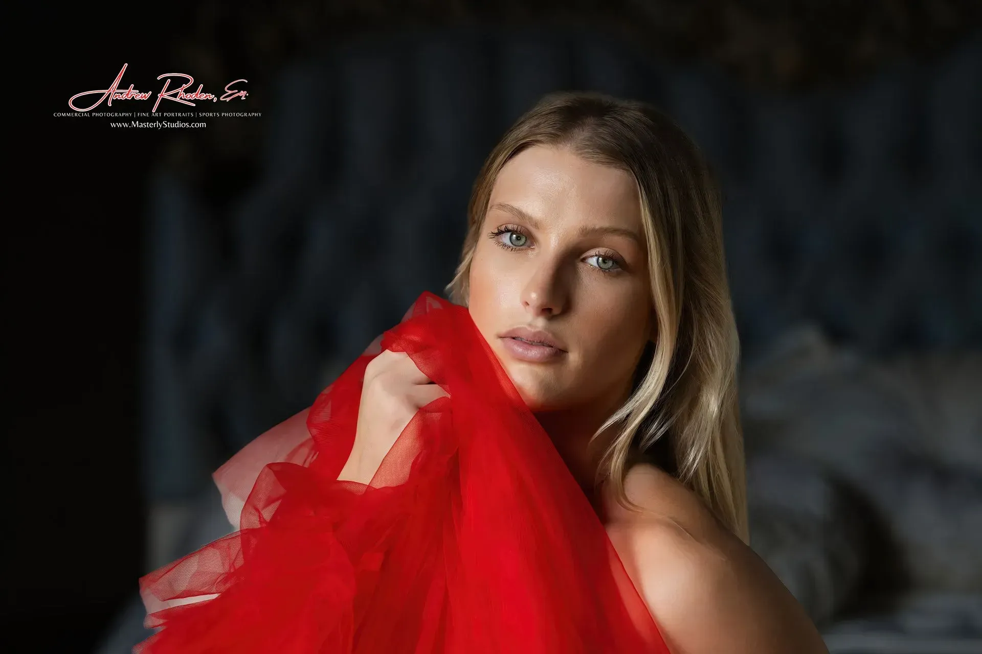 Blonde woman with closed eyes, side profile. Soft lighting, blurred background, black strap.