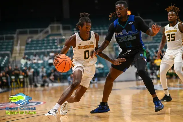 Basketball player in white dribbles past defender in black during an indoor game