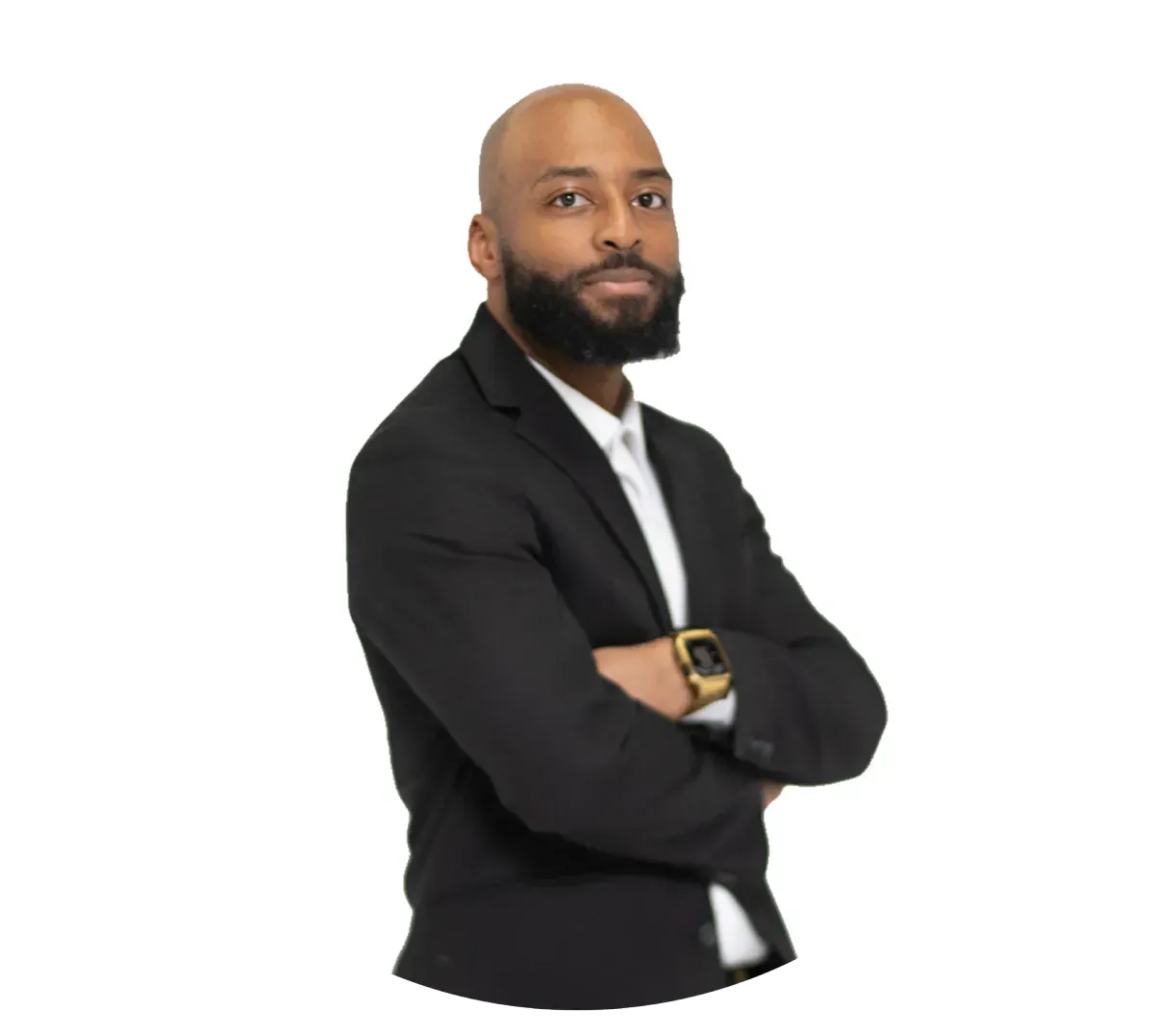 Man in a black blazer stands with arms crossed on a white background
