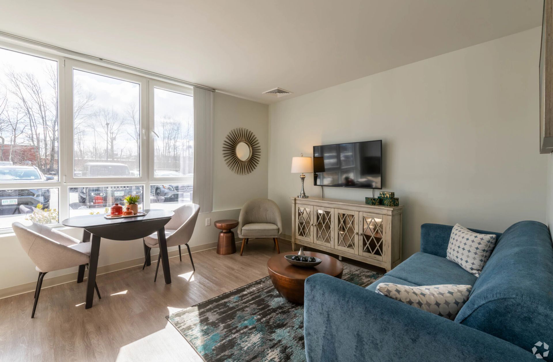 The modern living room at West End Yards with furniture and oversized windows. 