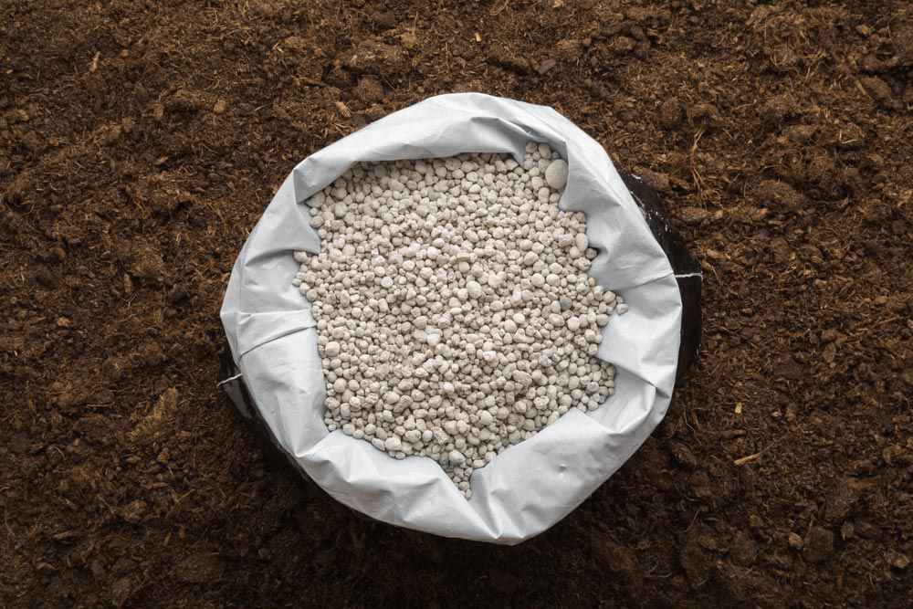 A Bag Of Fertilizer Is Sitting On Top Of A Pile Of Dirt — Mudgeeraba Landscape Centre In Mudgeeraba, QLD
