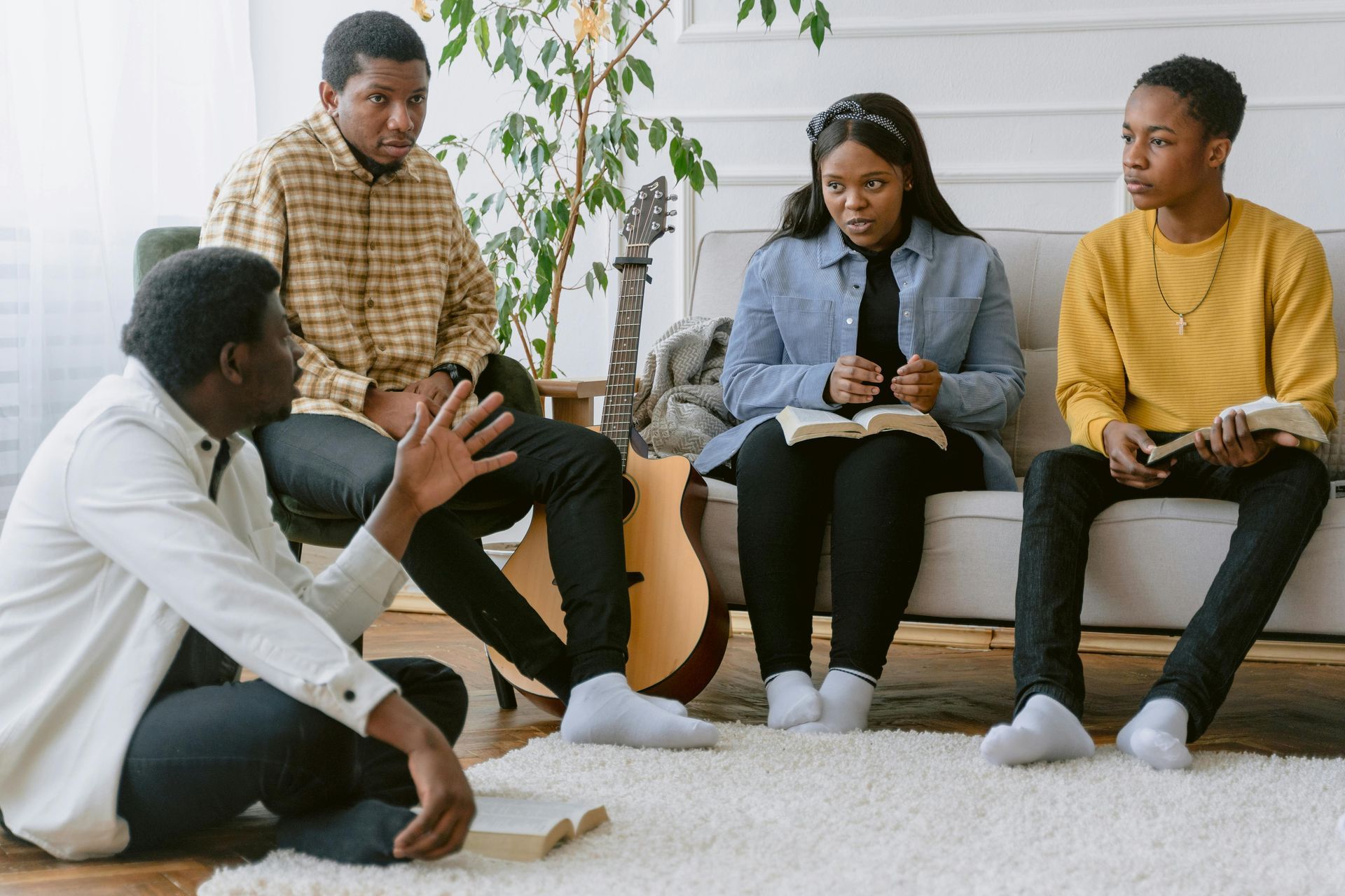 A group of people are sitting on a couch in a living room.