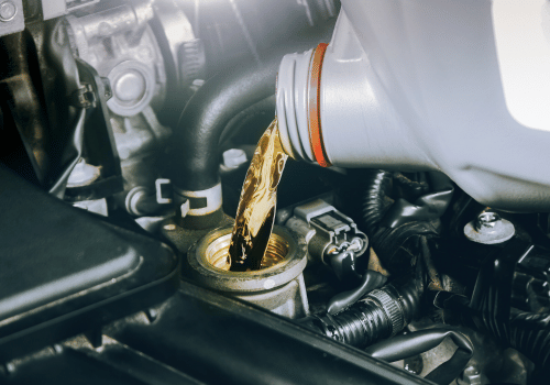 Motor oil being poured into an engine through the oil filler cap
