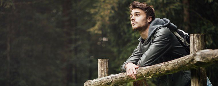 Young man standing on the bridge