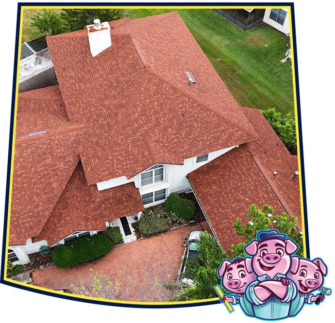 An aerial view of a house with a red shingled roof, featuring a cartoon illustration of three pigs in the corner.