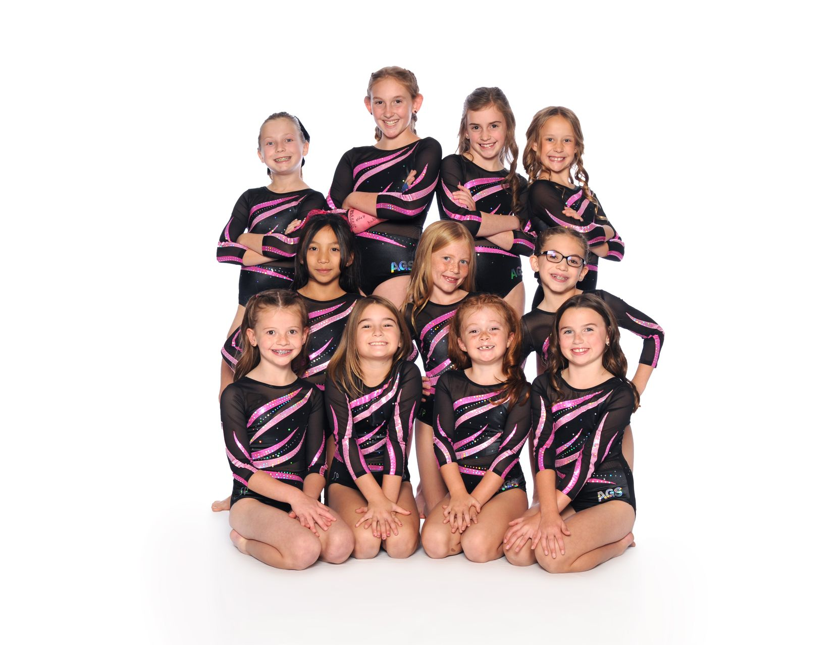 A group of young girls are posing for a picture.