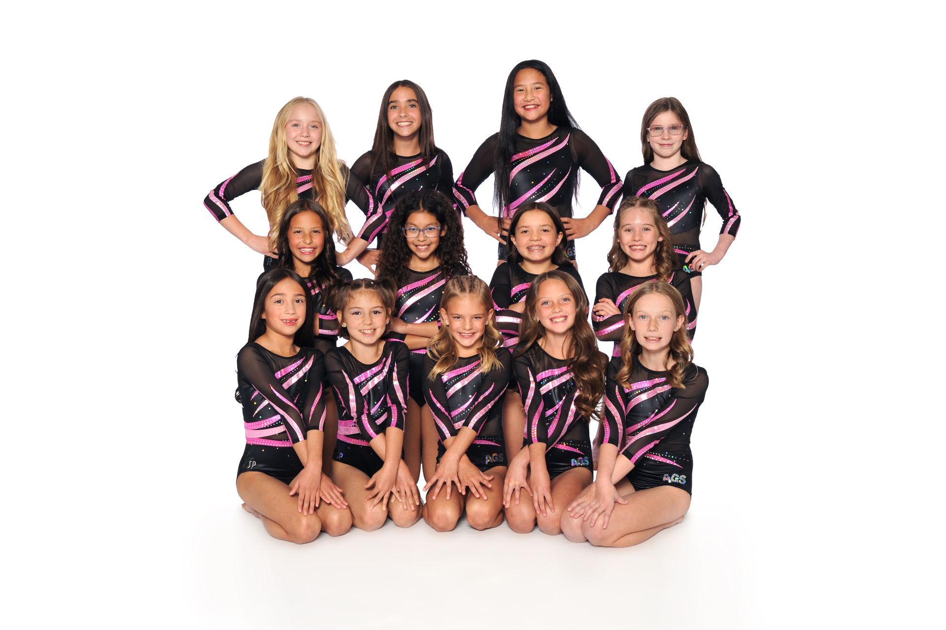 A group of young girls are posing for a picture.