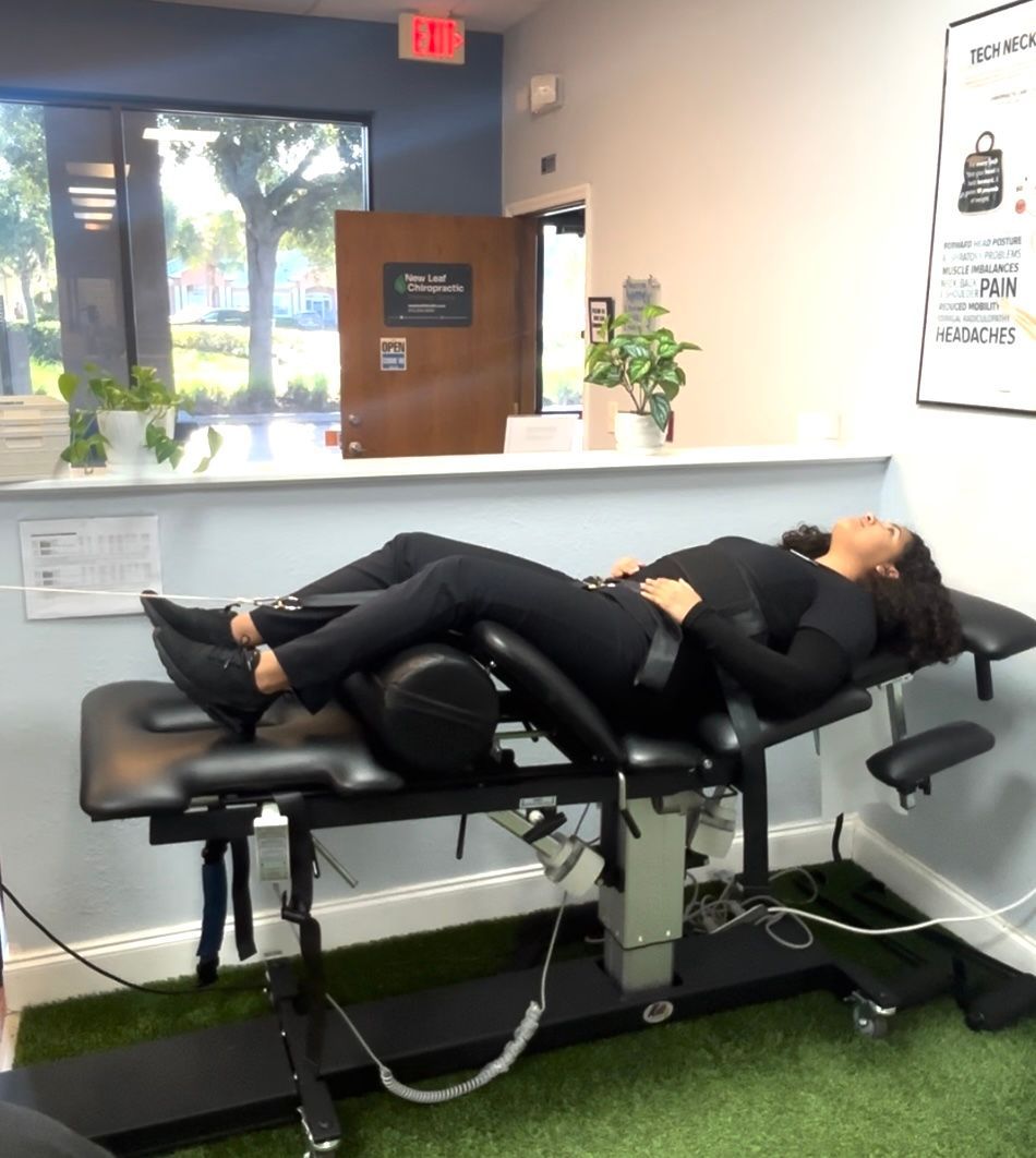 Person lying on a treatment table with wired electrodes attached in a clinical room.