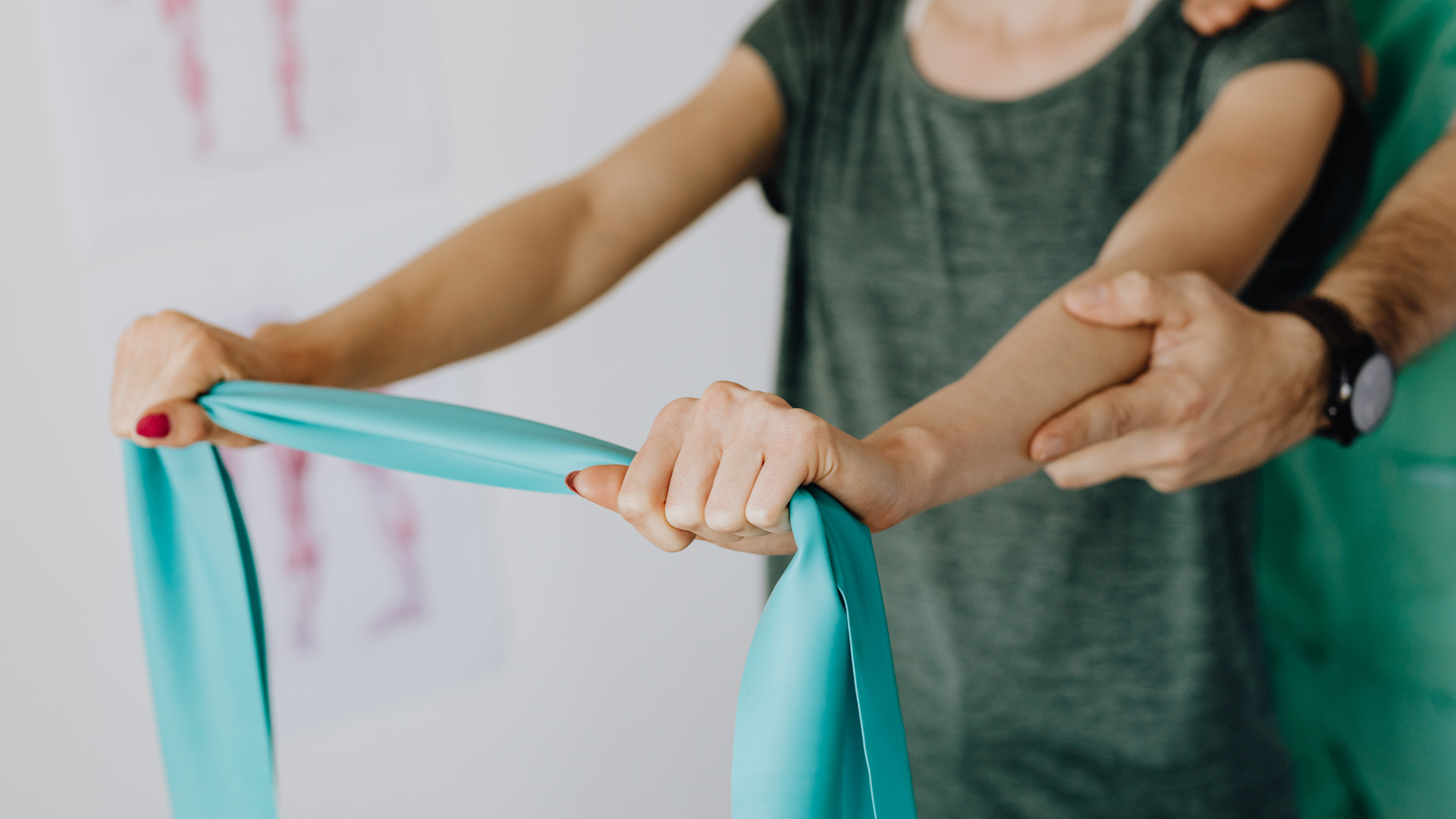 Hands stretching a turquoise resistance band during exercise therapy