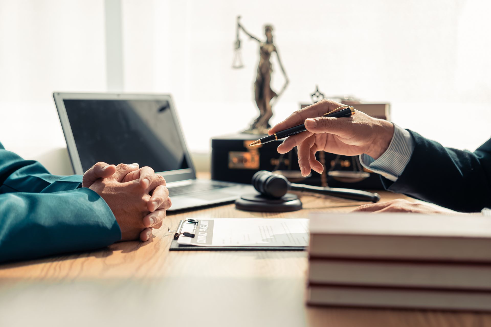 Divorce lawyer advising a male client across a legal desk during a men's divorce attorney consultation Divorce lawyer advising a male client across a legal desk during a men's divorce attorney consultation