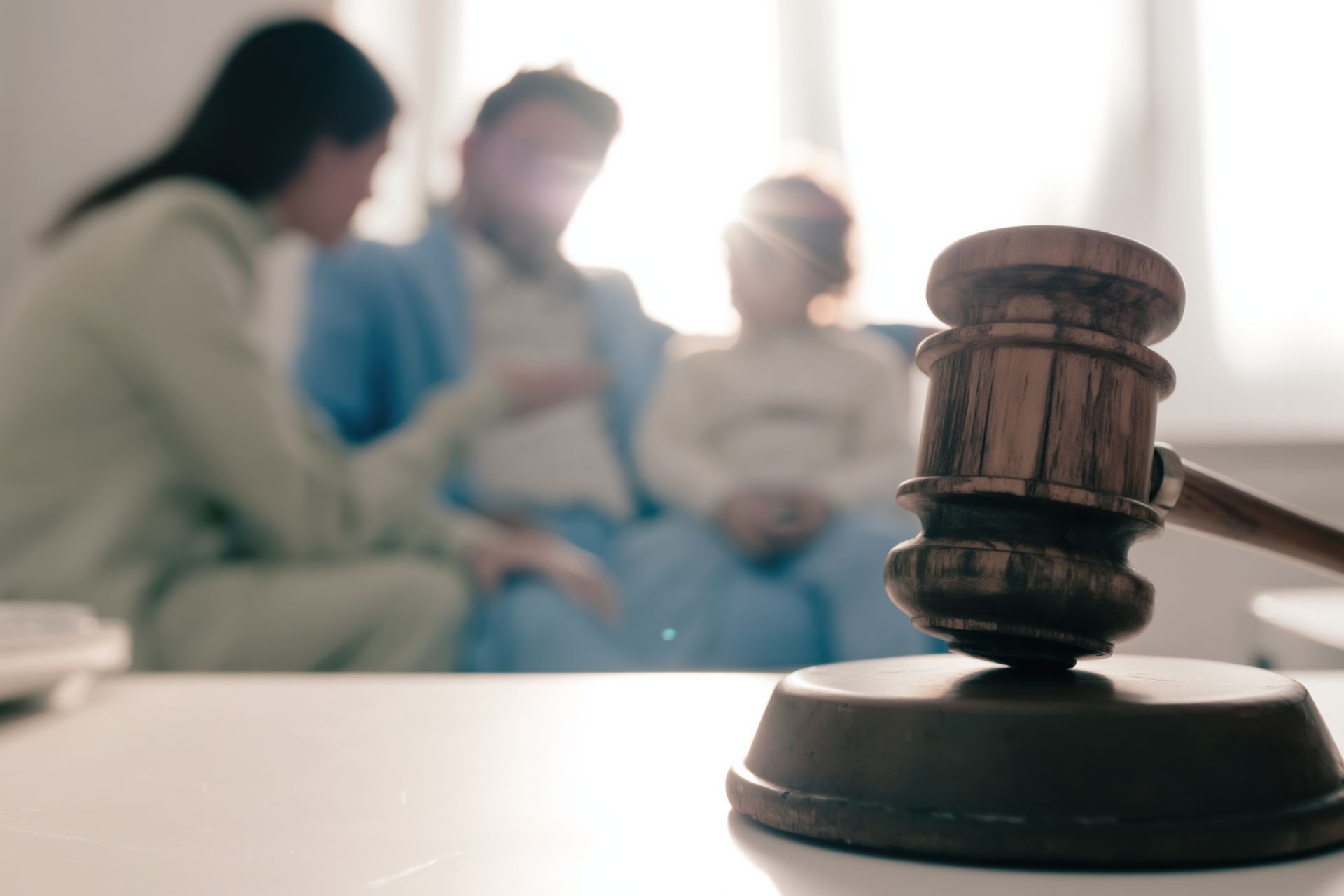 Judge's gavel in the foreground with a father and child in the background, representing fathers rights legal proceedings Judge's gavel in the foreground with a father and child in the background, representing fathers rights legal proceedings