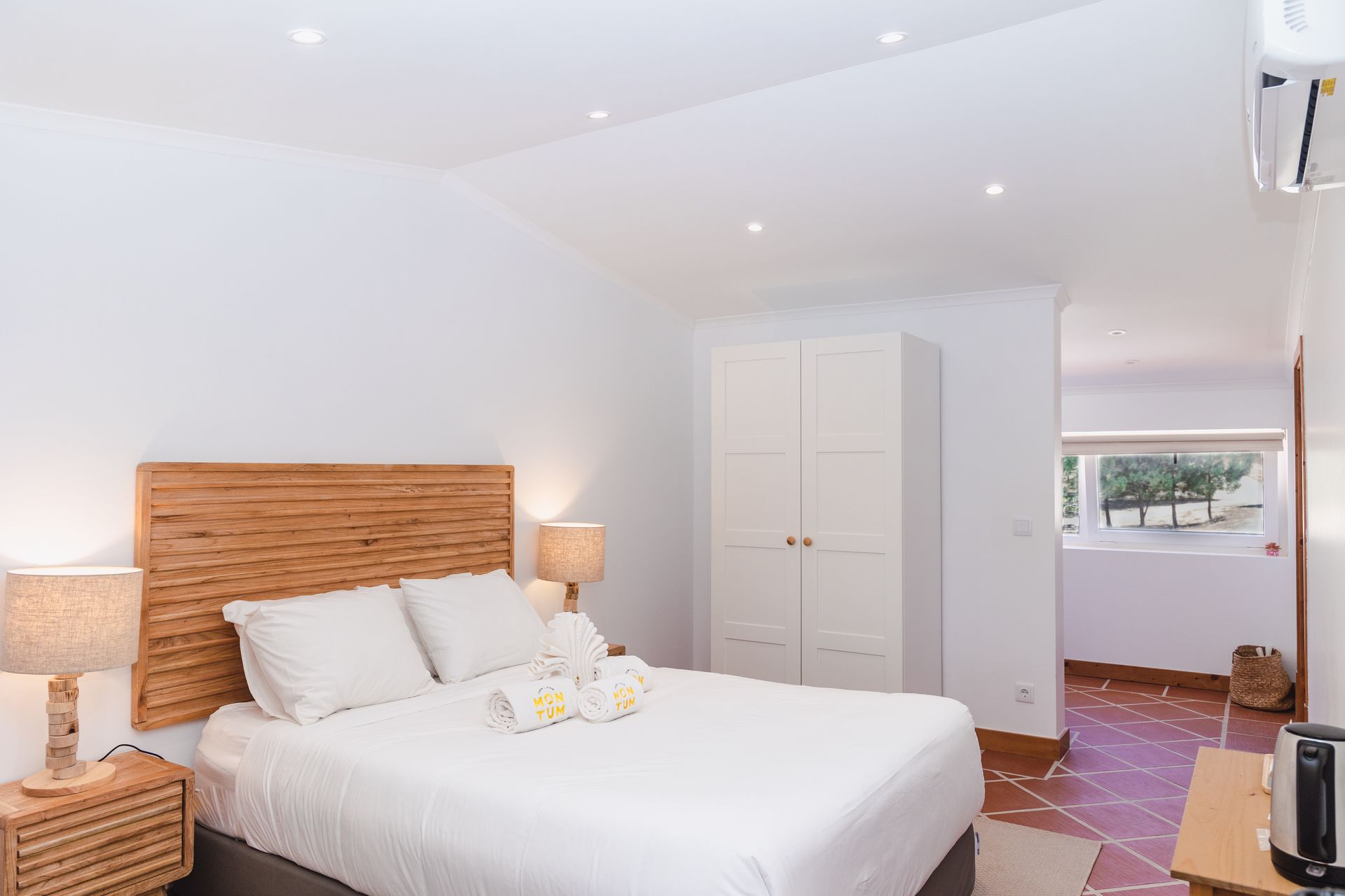 A bedroom with a king size bed and a television.