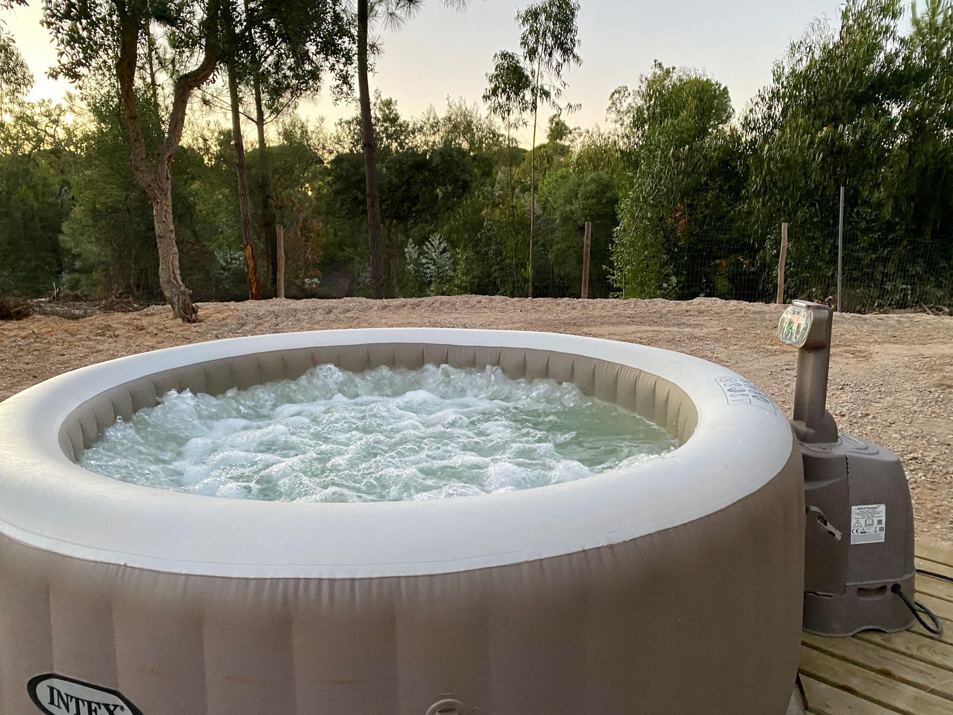 An inflatable hot tub is sitting on top of a wooden deck.