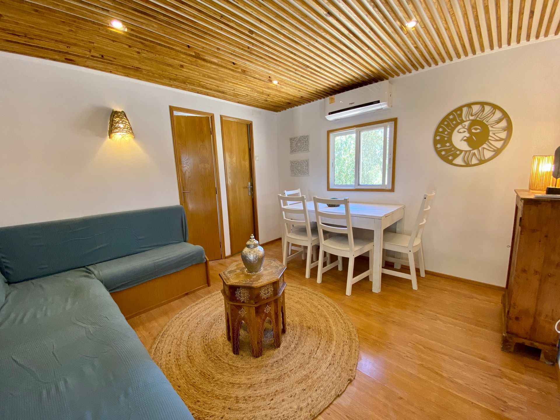 A living room with a couch , table and chairs.