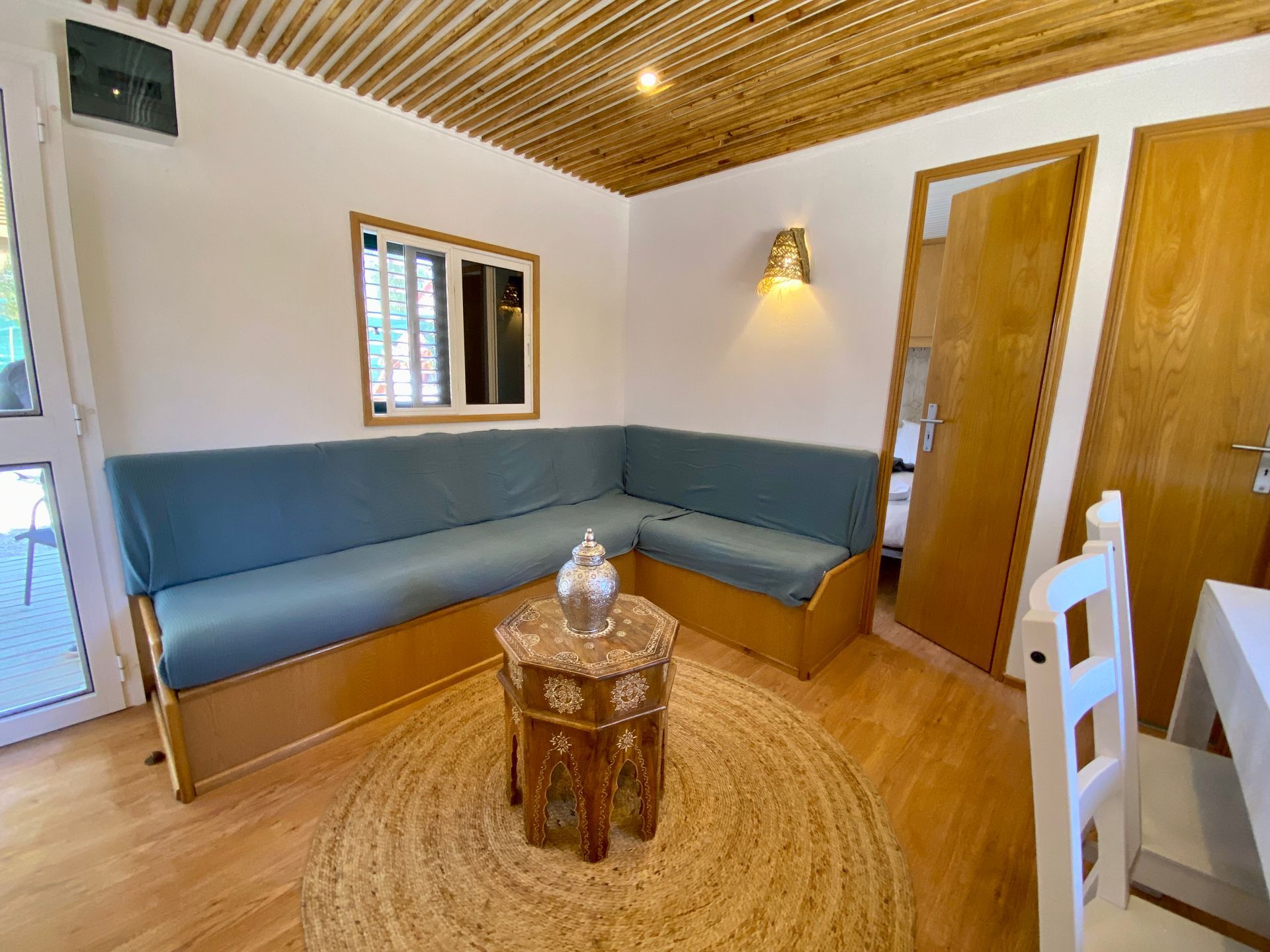 A living room with a couch , table and chairs.
