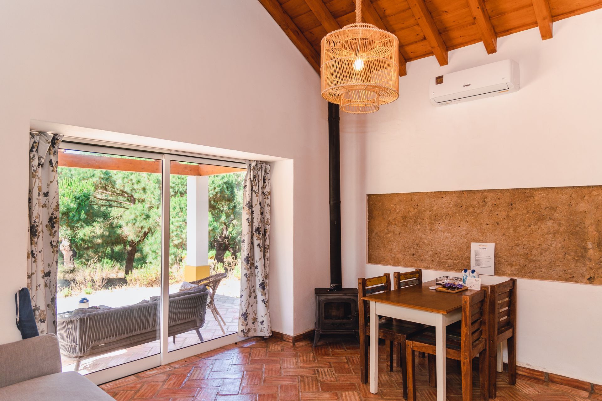 A living room with a table and chairs and a sliding glass door.