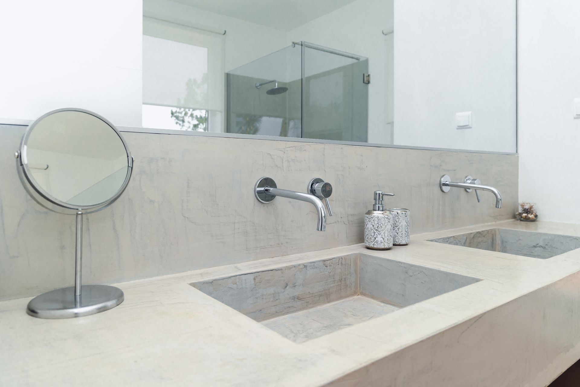 A bathroom with two sinks and a mirror.