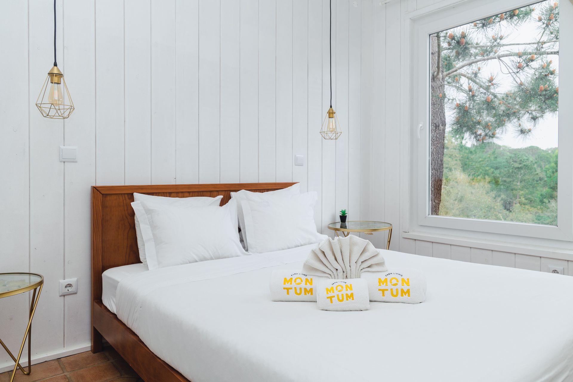 A bedroom with a large bed and a window.