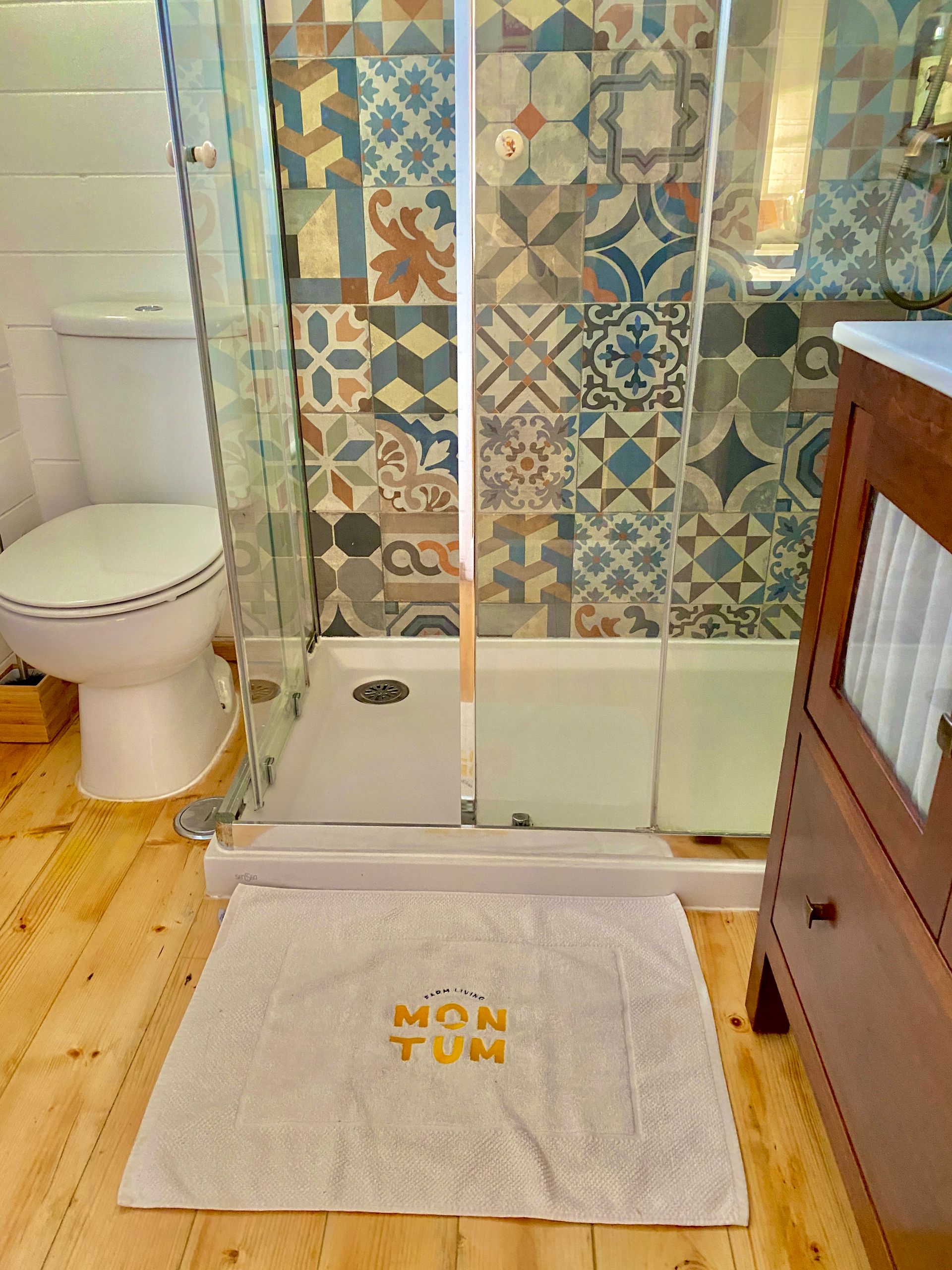 A bathroom with a toilet , sink , and shower.