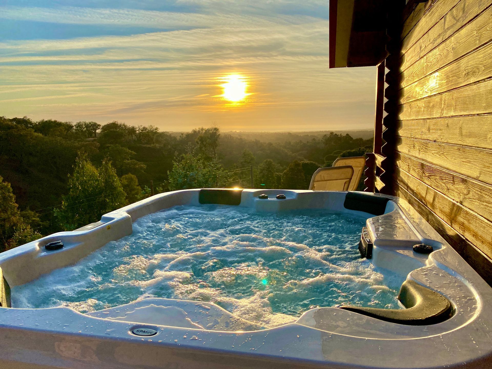There is a hot tub with a view of the sunset.