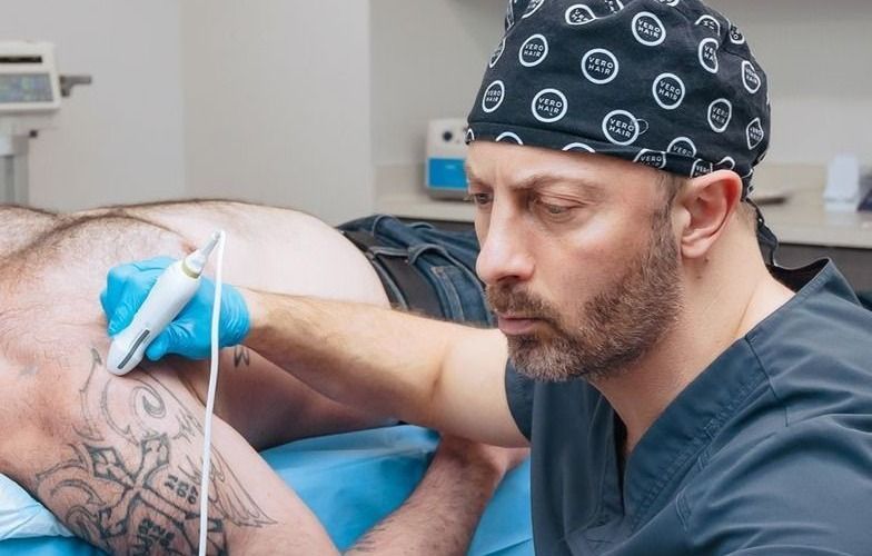 Dr. Alan Locke, DO, performing an ultrasound-guided shoulder injection for frozen shoulder at Spectrum Stem Cell & Regenerative Medicine Center in Wauwatosa, WI