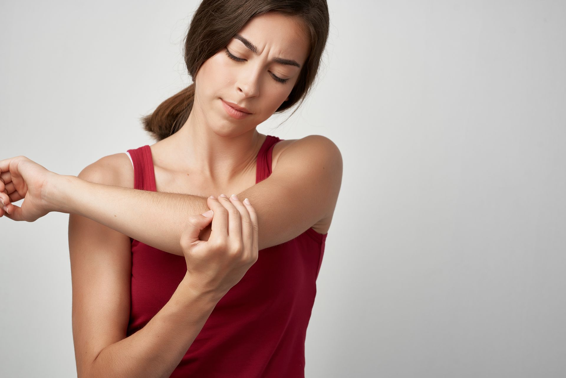 A Woman Looks at Her Elbow Bruised Pain