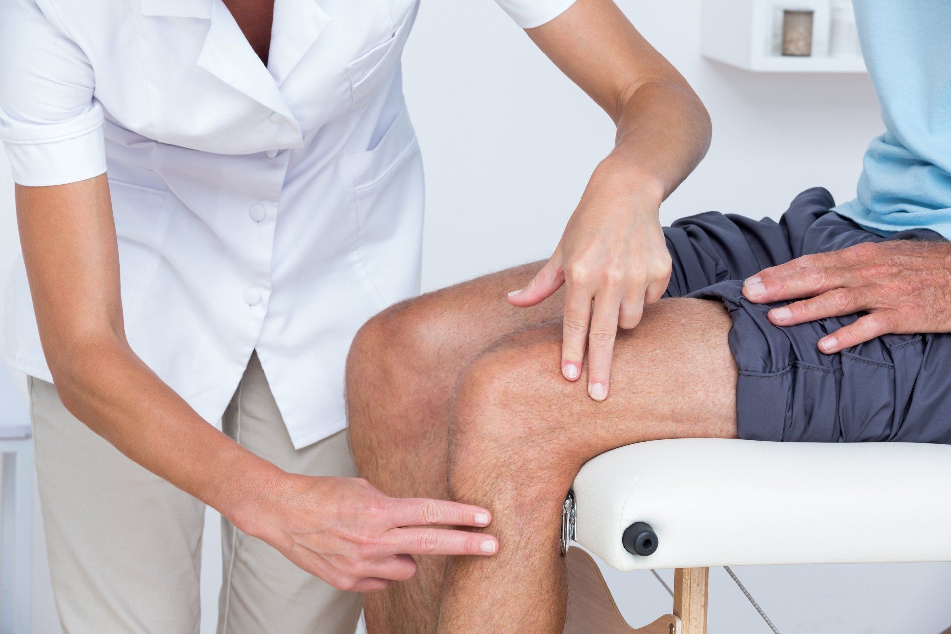 Doctor Examining Her Patient Knee in Medical