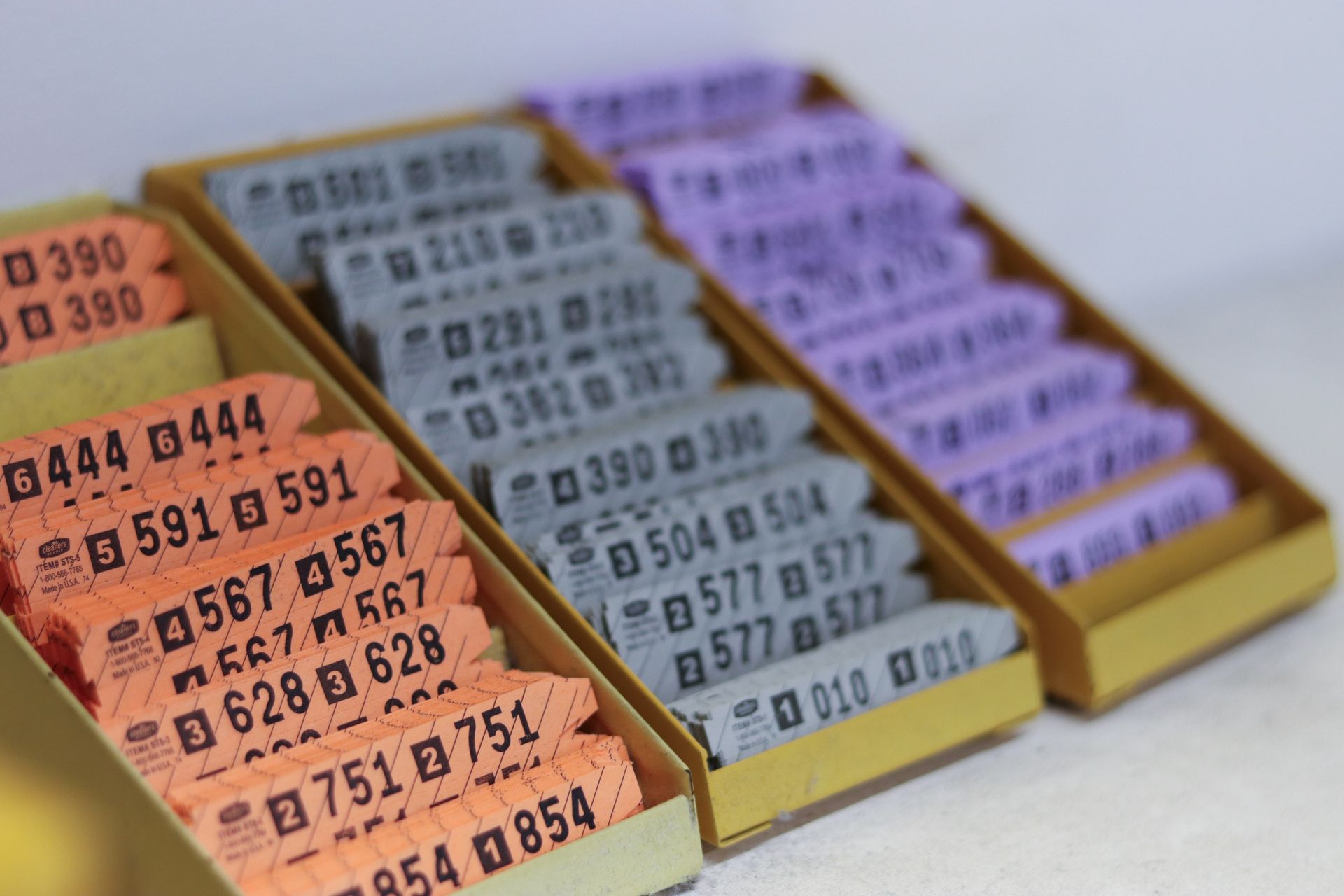 Colored dry-cleaning tickets in boxes.