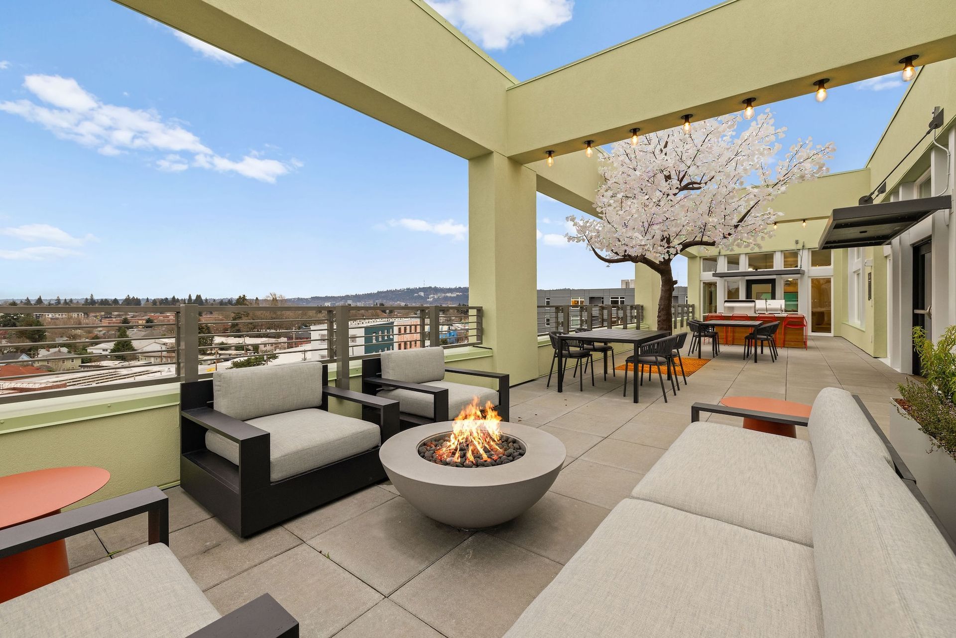 Rooftop patio with fire pit, lounge seating, dining area, and mountain views