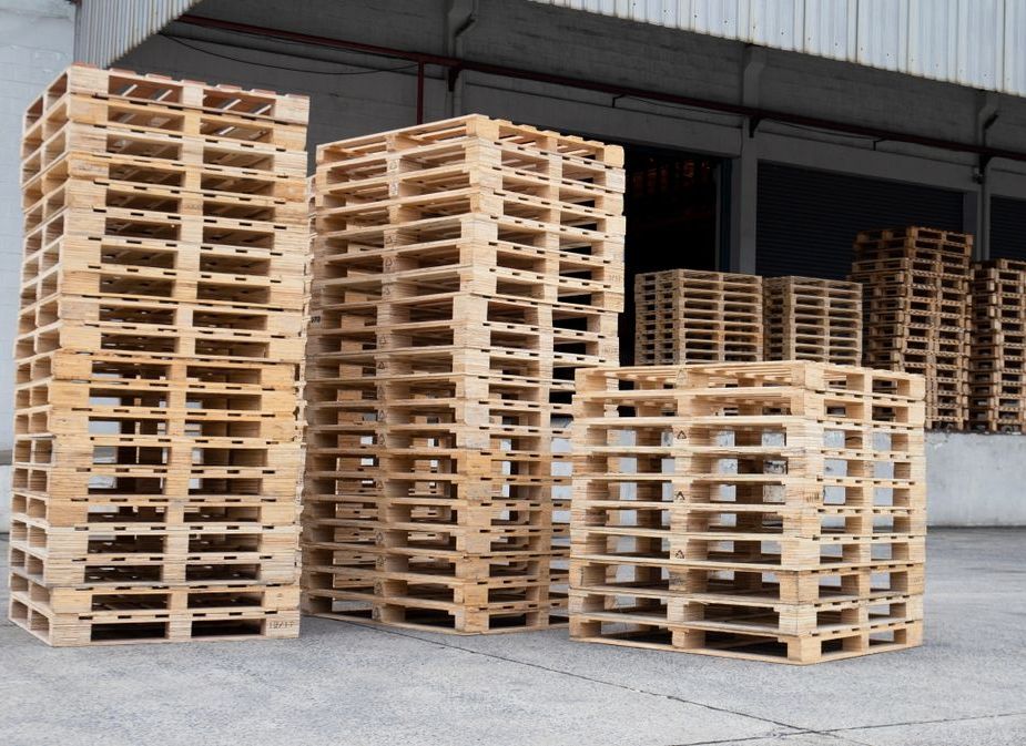 Empty pallets stacked on a dock waiting for palletization
