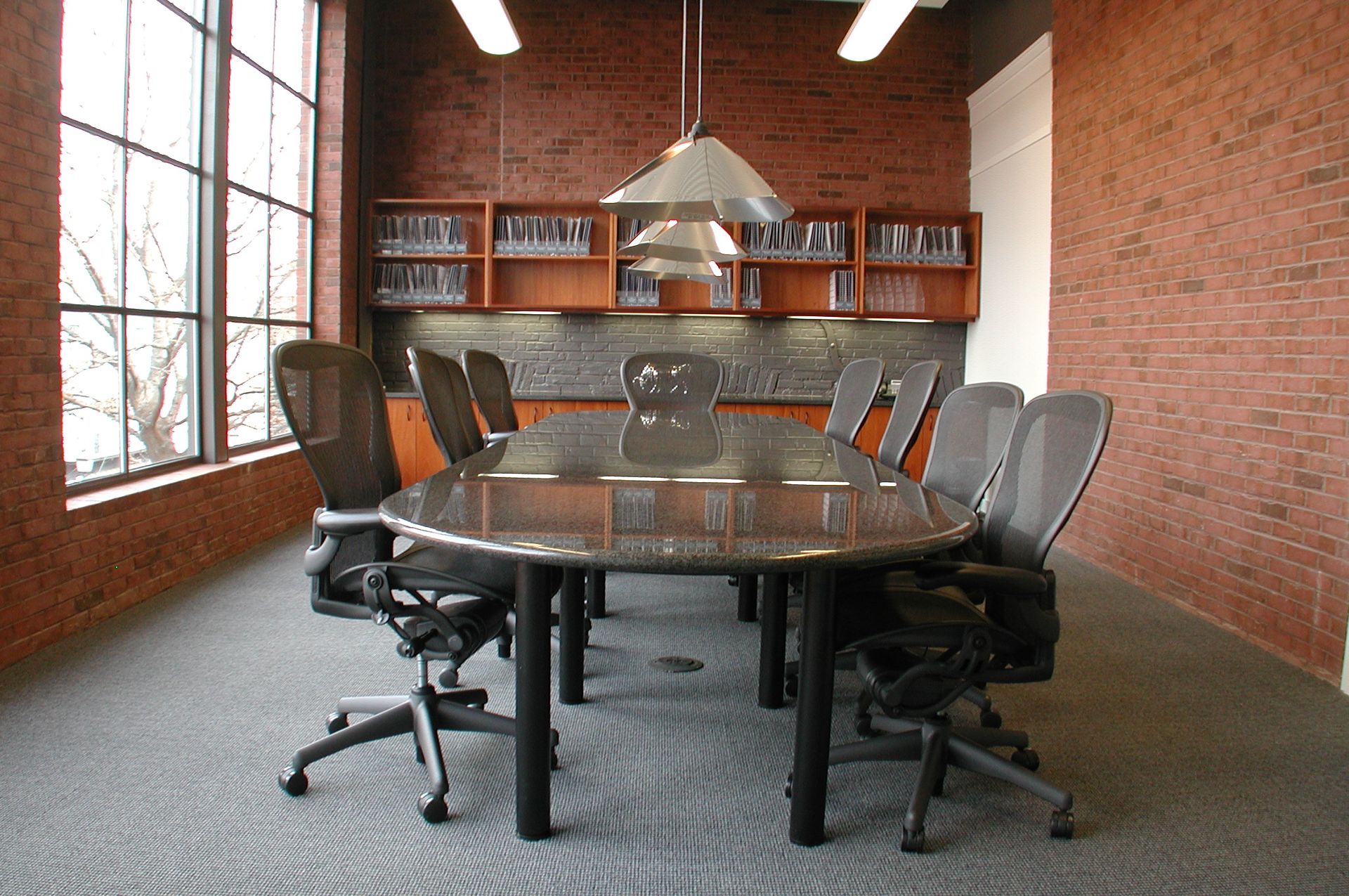 A conference room with a long table and chairs