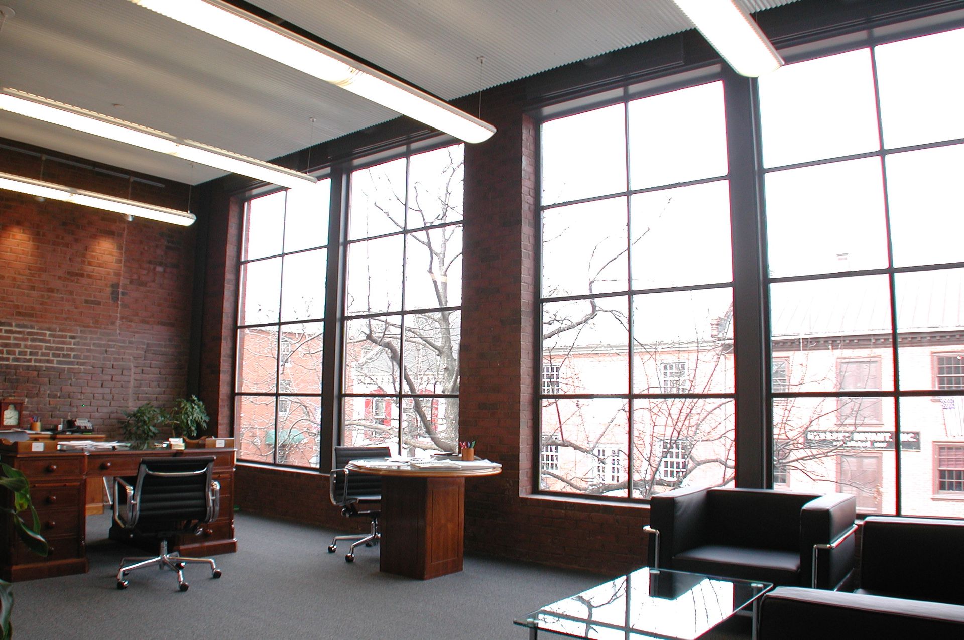 A room with a lot of windows and chairs