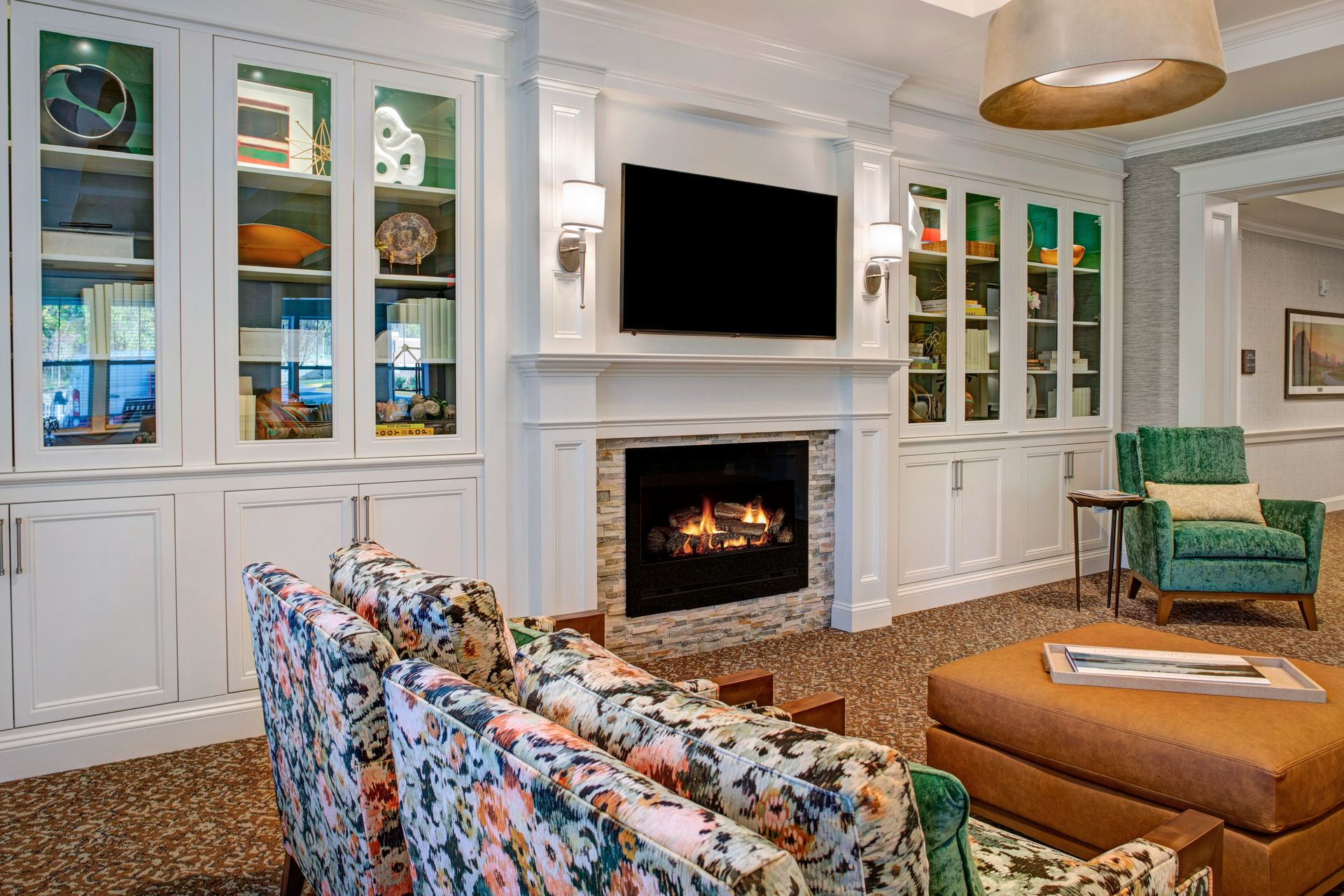 A living room with a fireplace and a flat screen tv.