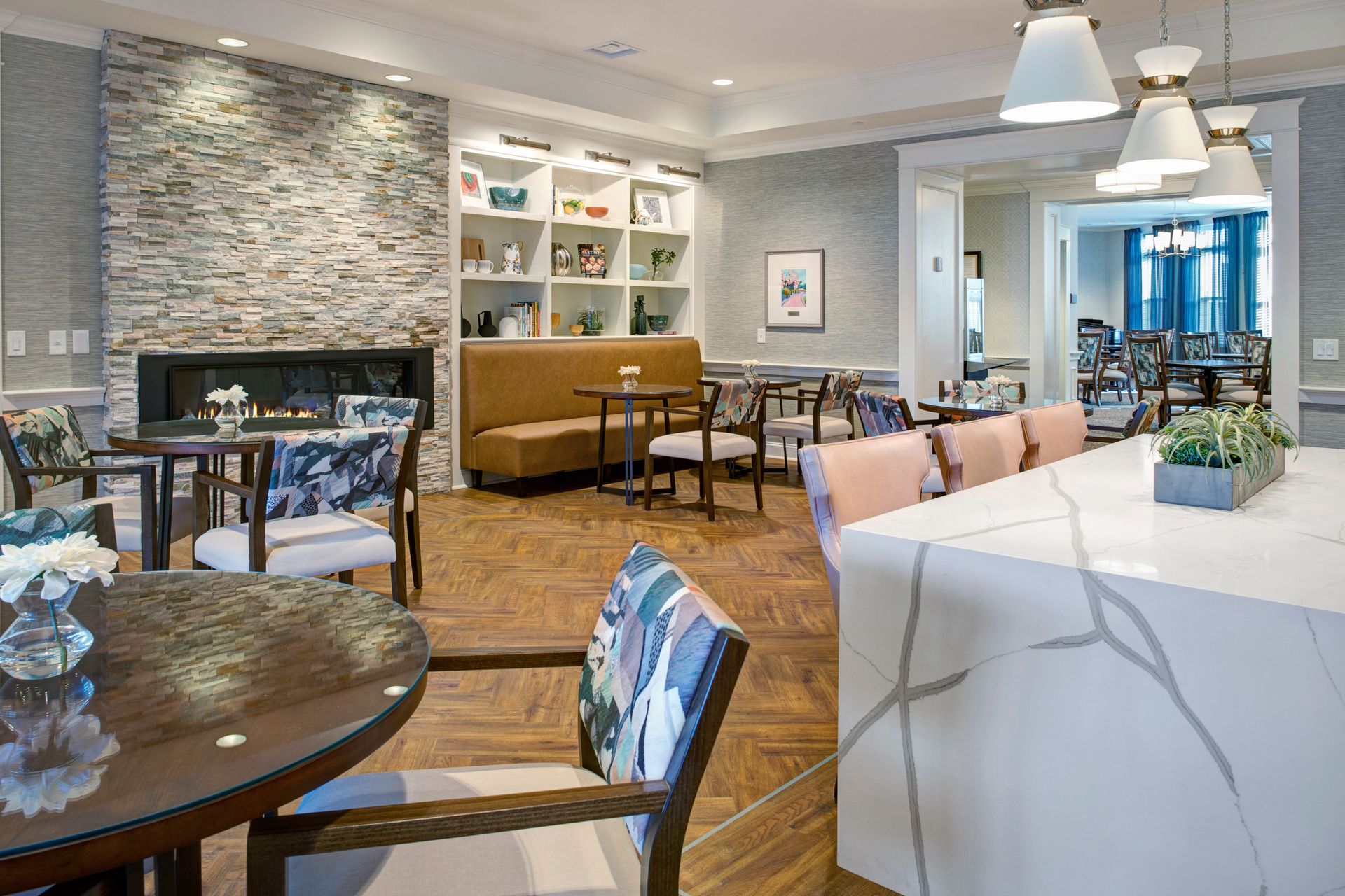 A living room with tables and chairs and a fireplace.
