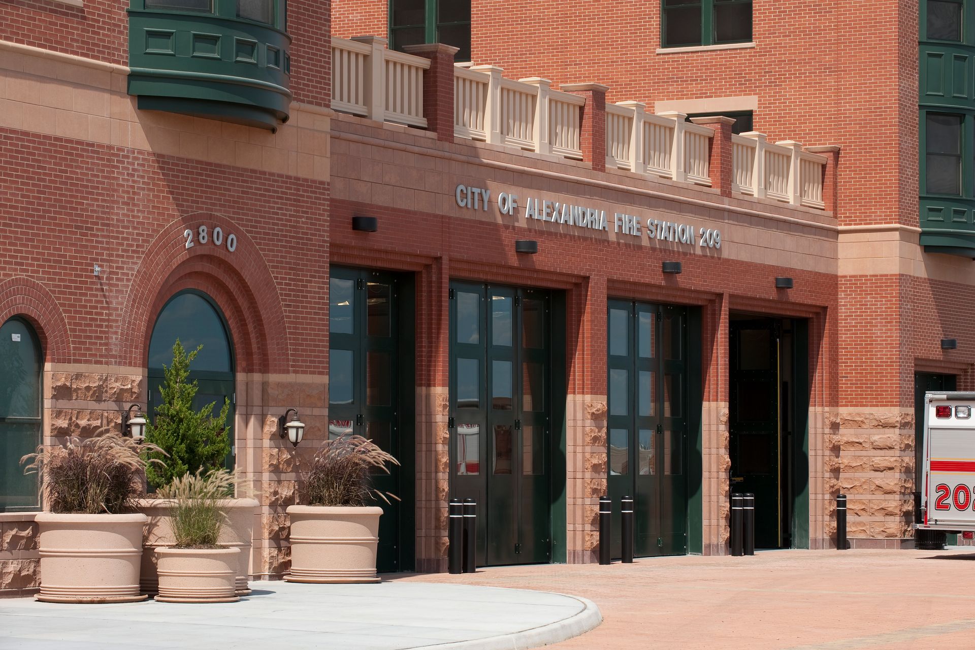 An ambulance is parked in front of a fire station