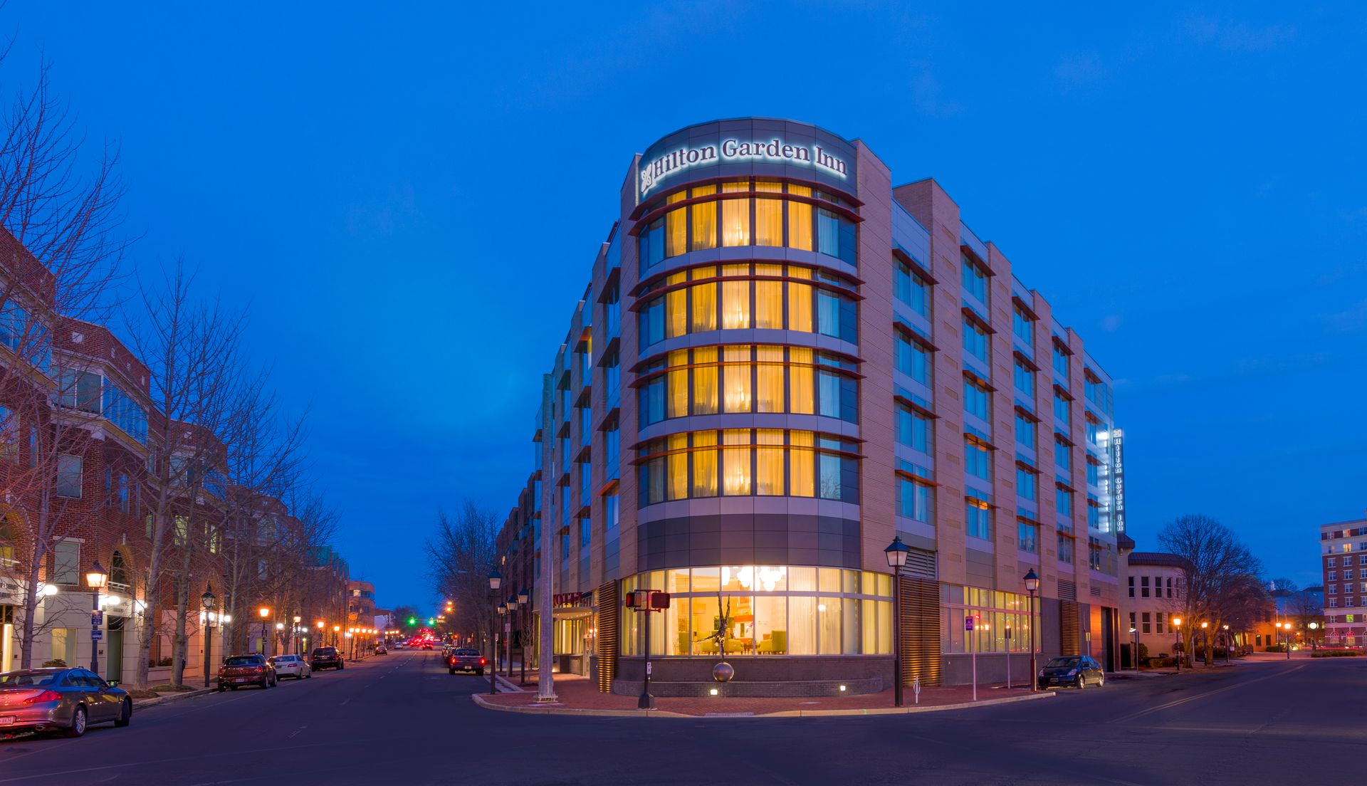 A large building with a lot of windows is lit up at night.