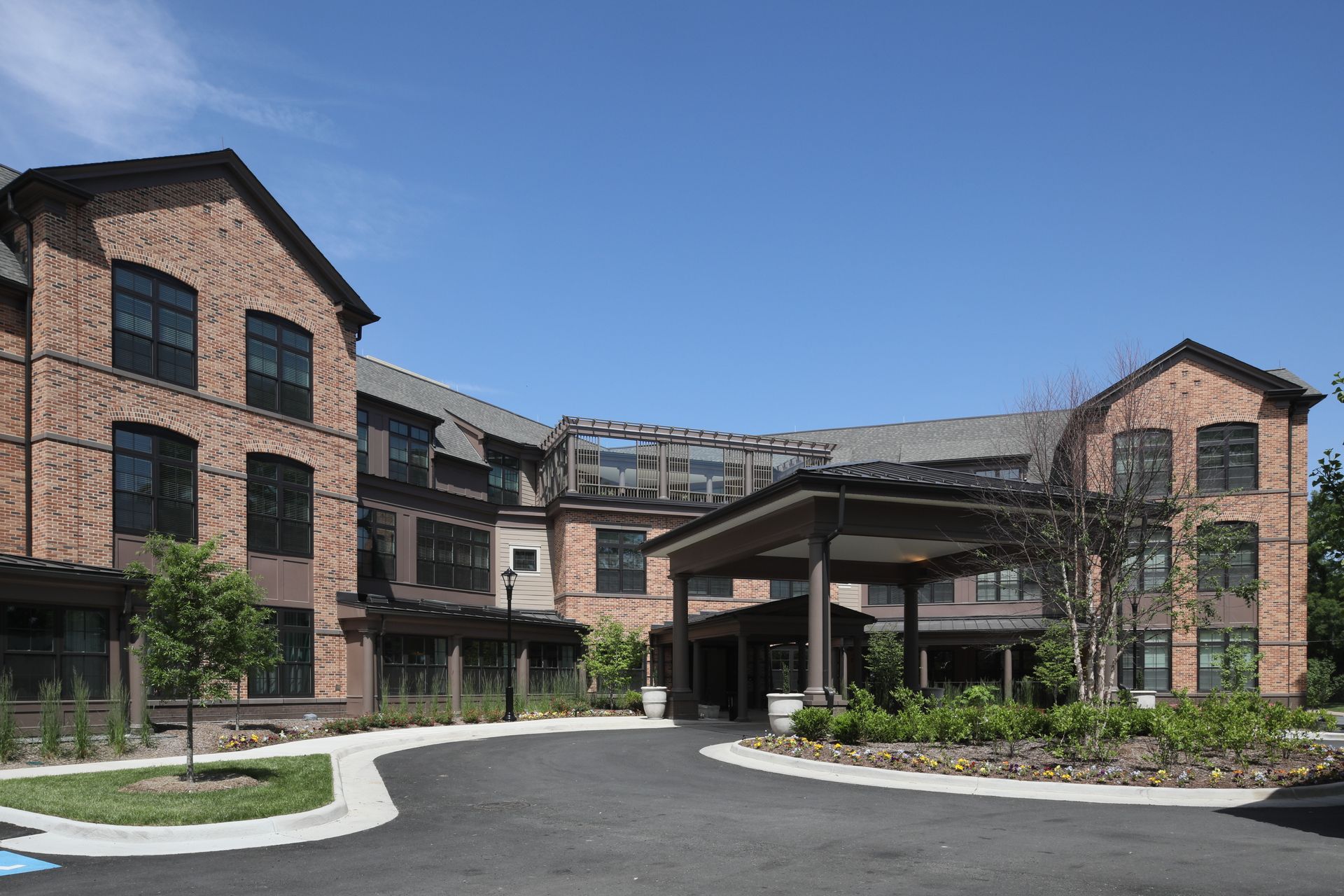 A large brick building with a driveway leading to it