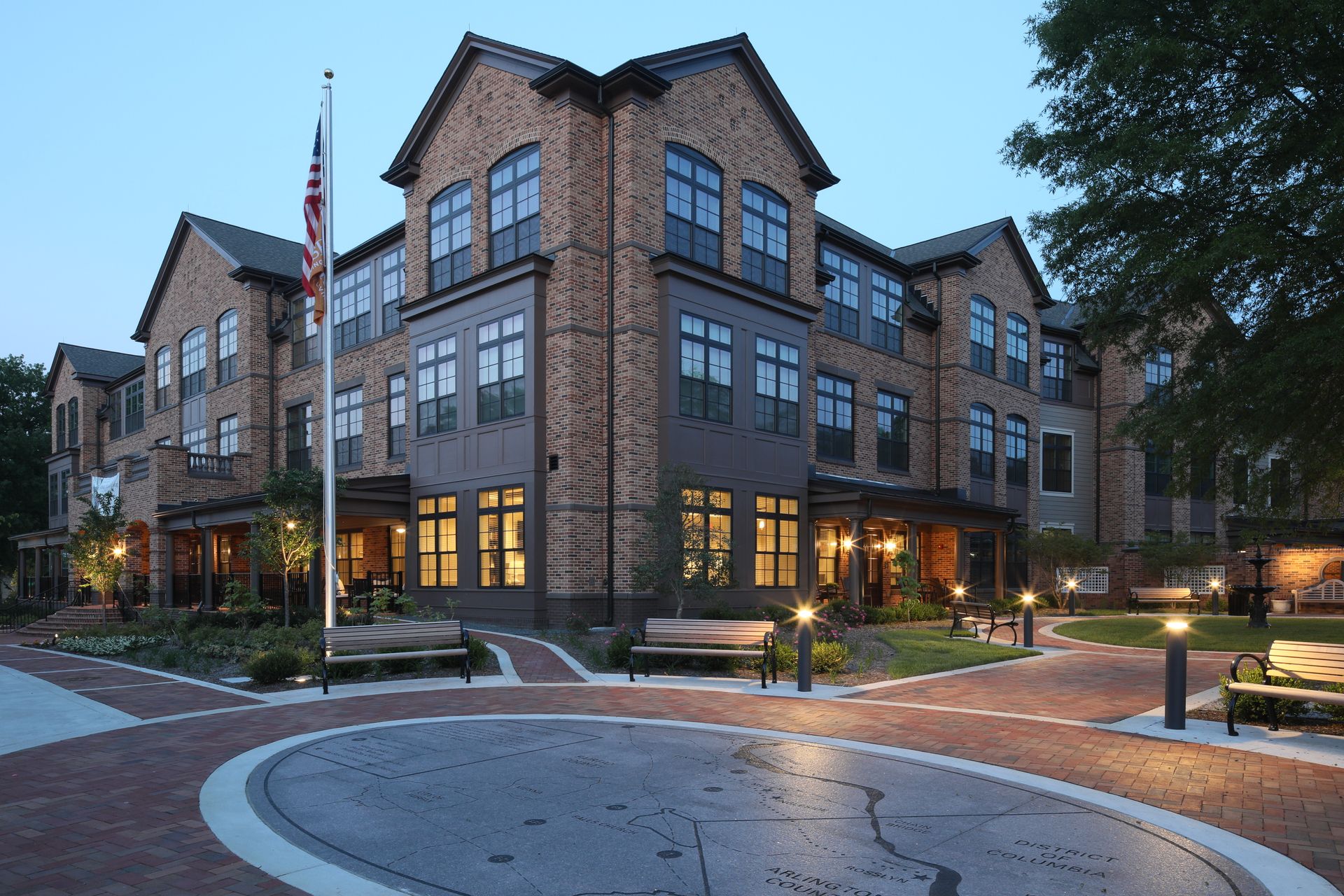 A large brick building with a flag in front of it