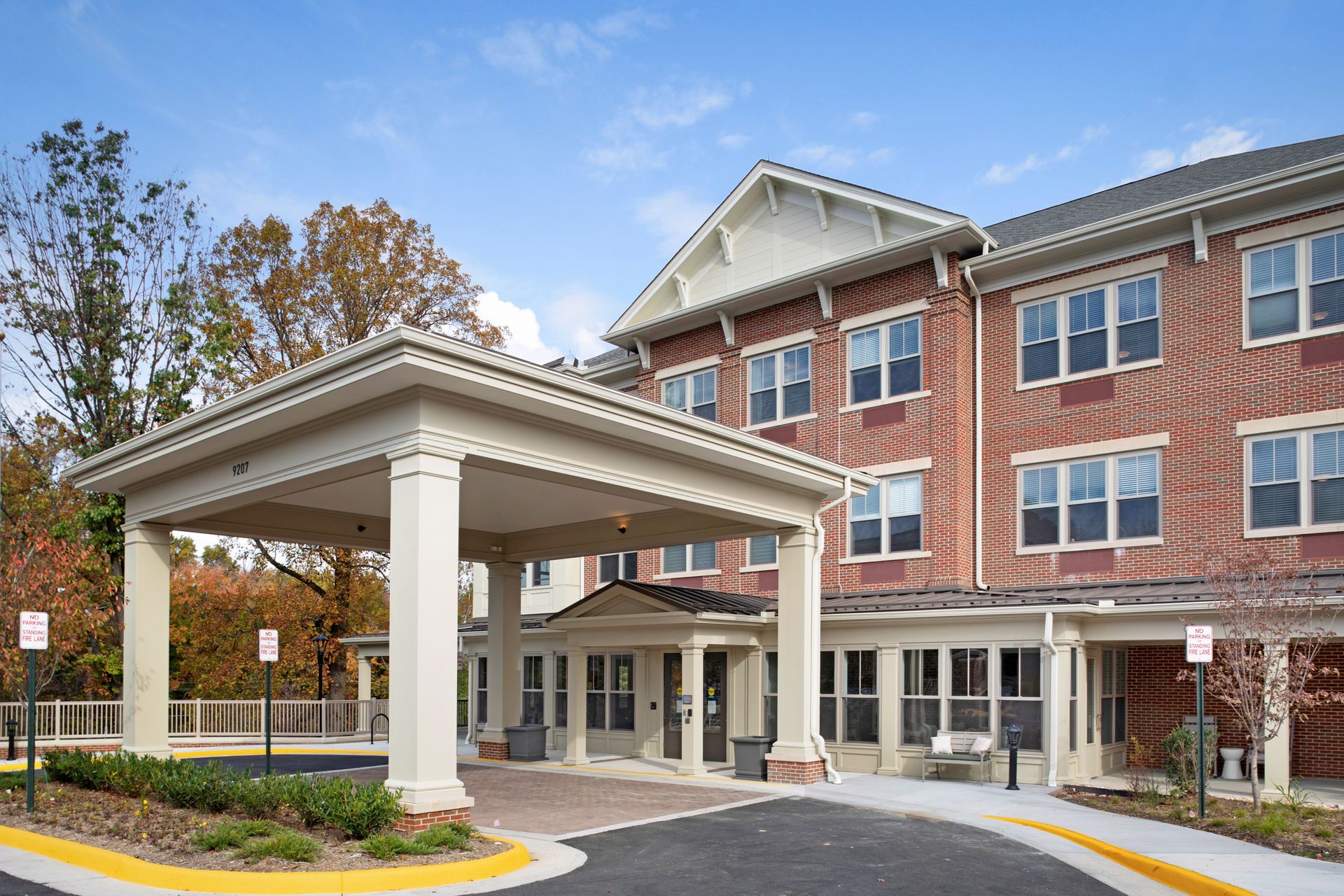 A large brick building with a white awning over the entrance.