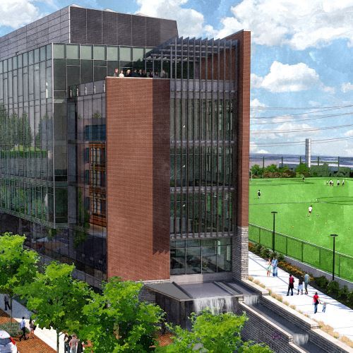 An artist 's impression of a large building with a soccer field in the background