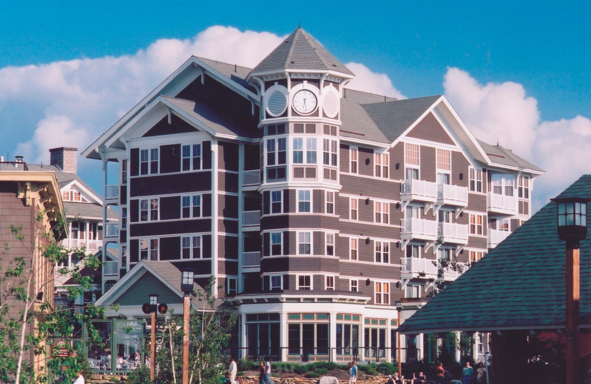 A large brown and white building with a blue sky in the background
